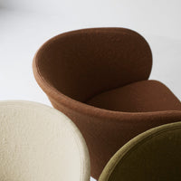 Chic, cozy chairs in cream, rich brown, and muted olive, featuring soft textures and modern silhouettes.