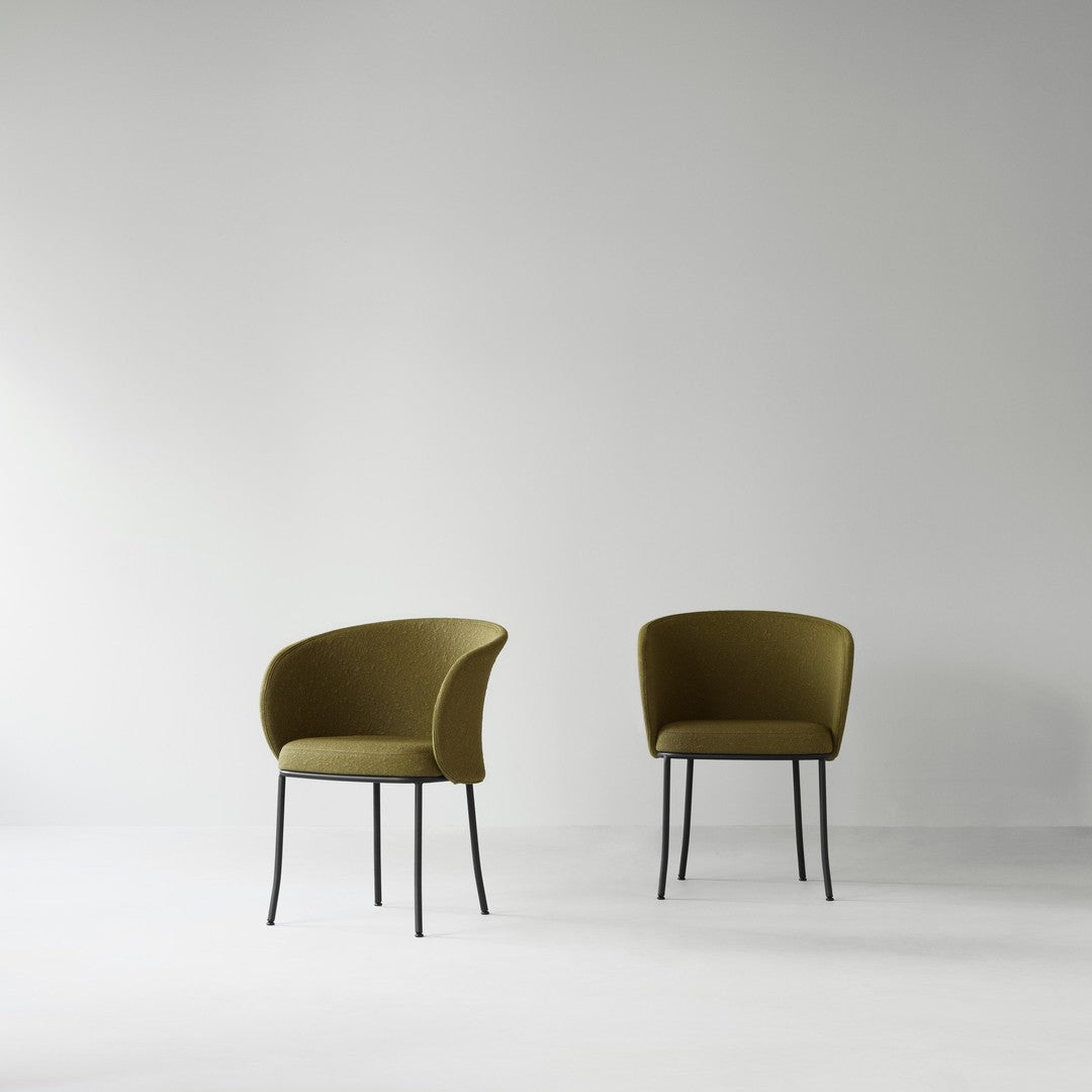 Olive green upholstered chairs with sleek black metal legs, set against a minimalistic white background.