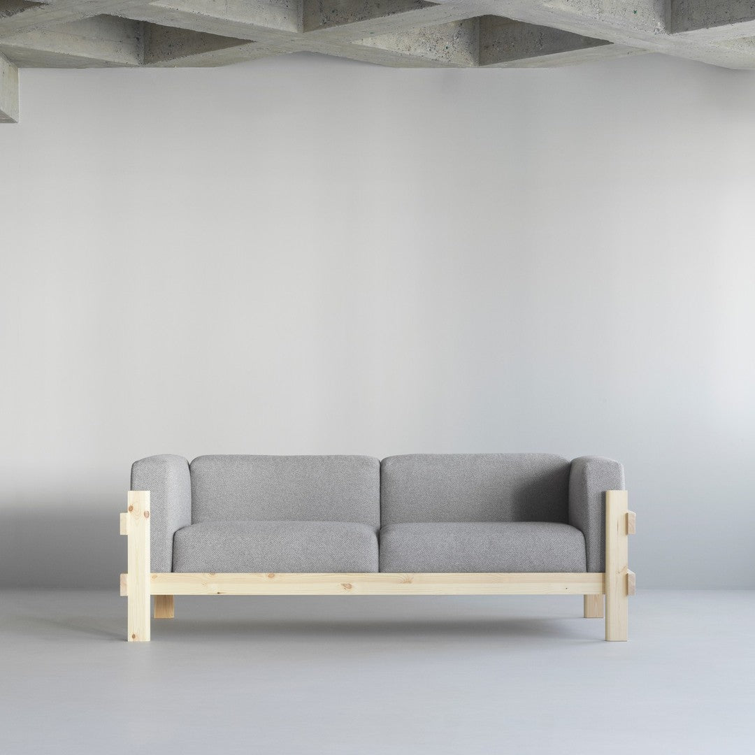 Gray upholstered sofa with light wood frame, featuring a minimalist design in a modern space.