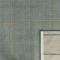 Gray fabric featuring a grid pattern with yellow stitching and a natural linen edge detail. Perfect for home decor.