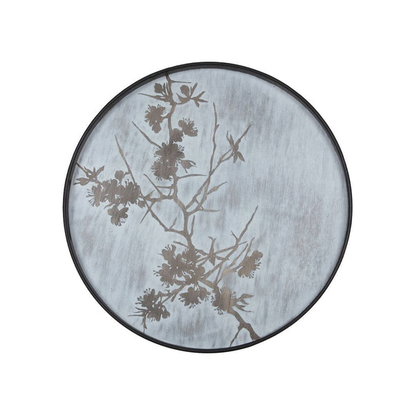 Round plate with a soft blue background and delicate black floral silhouettes. Elegant and modern design.