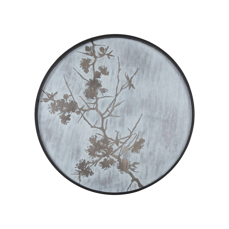 Round plate with a soft blue background and delicate black floral silhouettes. Elegant and modern design.