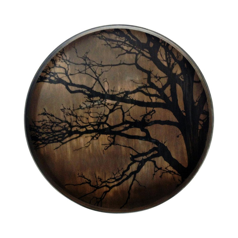 Dark tree silhouette against a warm, muted brown background, featuring intricate patterns and a circular shape.