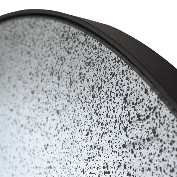 Round plate featuring a speckled black and white pattern with a sleek black edge. Ideal for modern table settings.