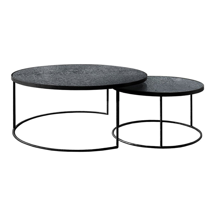 Black circular coffee tables with textured surfaces and sleek black metal frames, perfect for modern decor.