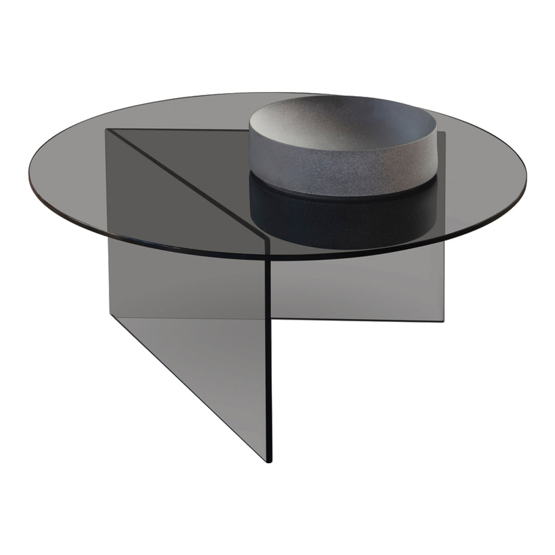 Black glass round coffee table with a geometric design and smooth surface, complemented by a minimalist gray bowl.