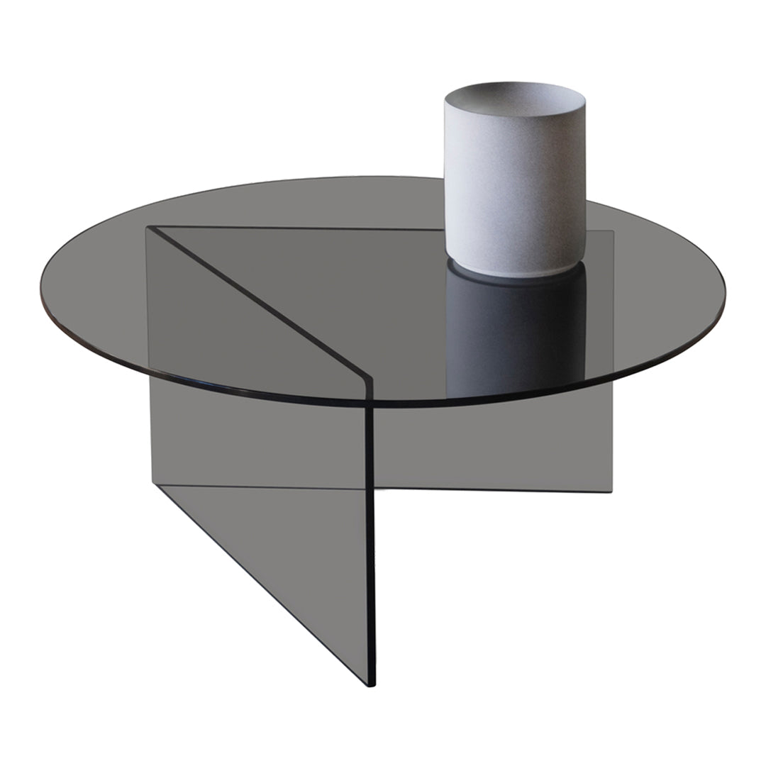 Round glass coffee table with a sleek black surface and minimalist geometric pattern. Perfect for modern decor.
