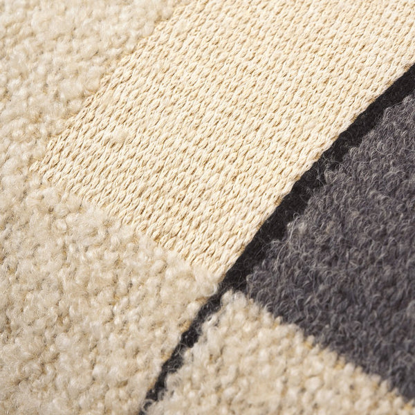 Textured fabric featuring cream, beige, and charcoal colors with a woven pattern. Perfect for cozy decor.