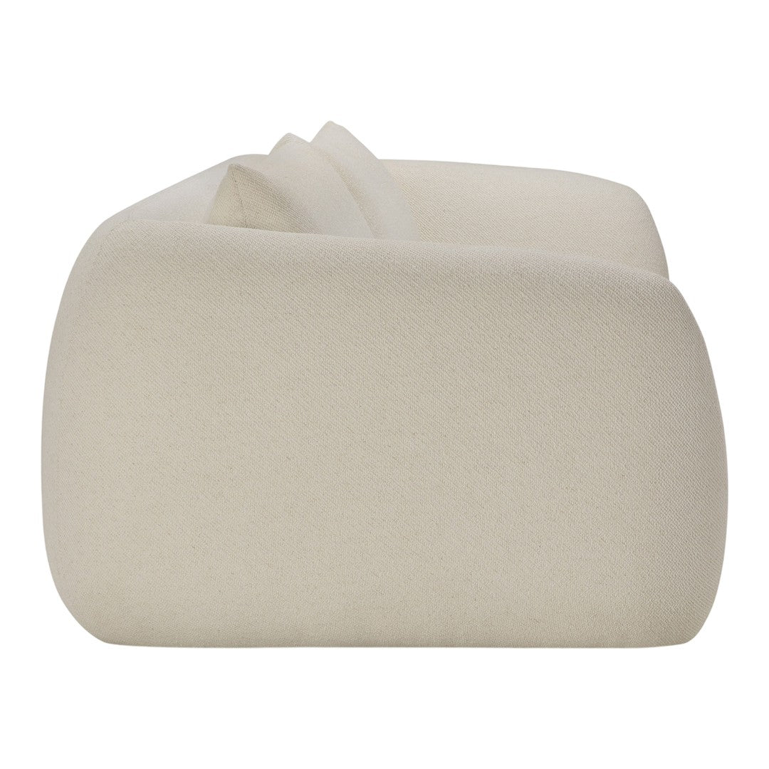 Beige plush textured sofa with smooth, minimalist design and curvy edges. Perfect for modern home decor.