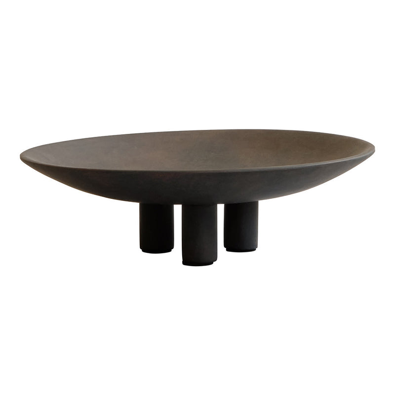 Round black ceramic bowl with a matte finish and three sturdy legs, showcasing a modern minimalist design.
