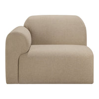 Tan curved accent chair with soft texture and minimalist design, perfect for modern interiors.