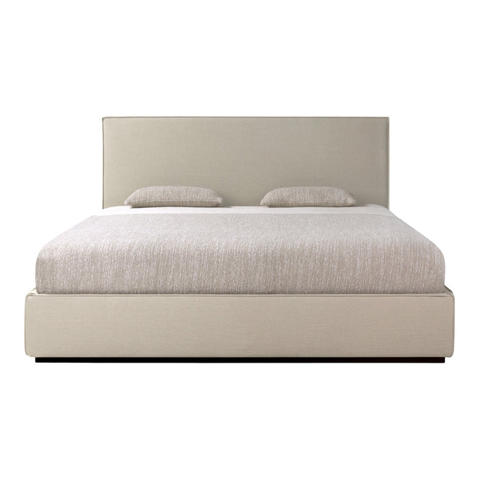 Light beige upholstered bed with a textured headboard and neutral-toned bedding for a modern, serene look.