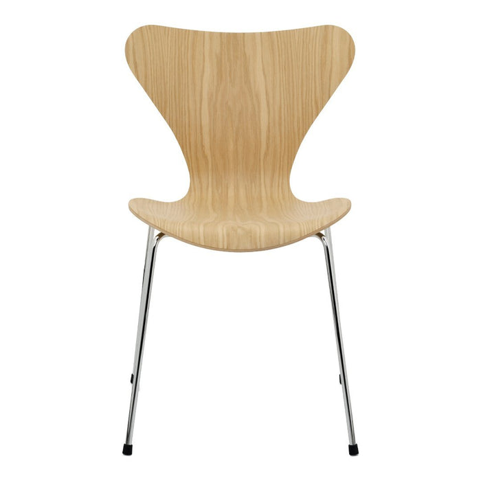 Natural wood finish chair with a smooth, curved silhouette and shiny chrome legs. Modern, minimalist design.