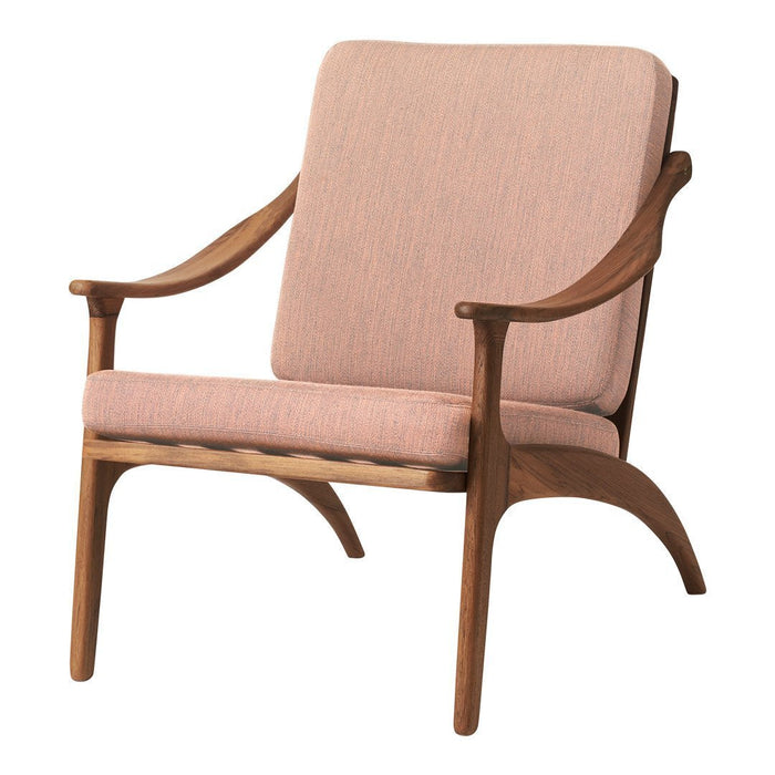 Soft pink upholstery with a subtle texture and warm wood accents in a mid-century modern chair design.