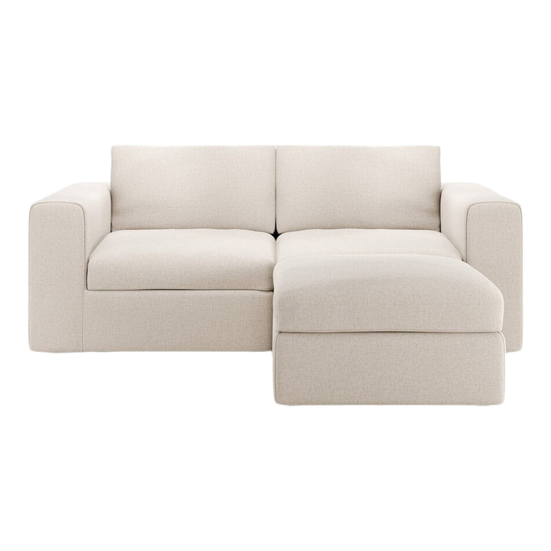 Beige fabric modular sectional sofa with a smooth texture and minimalist design, perfect for modern living spaces.