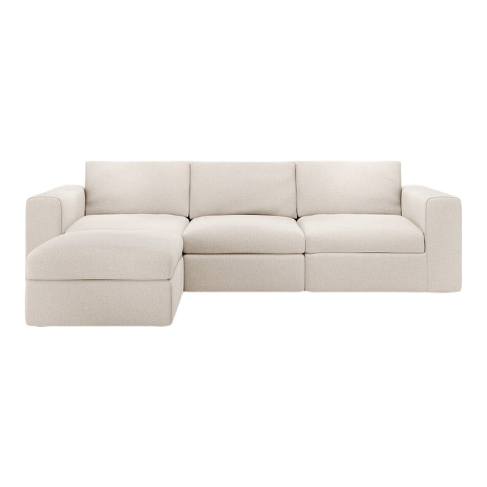 Soft beige sectional sofa with a textured, minimalistic design, featuring clean lines and cozy, plush cushions.