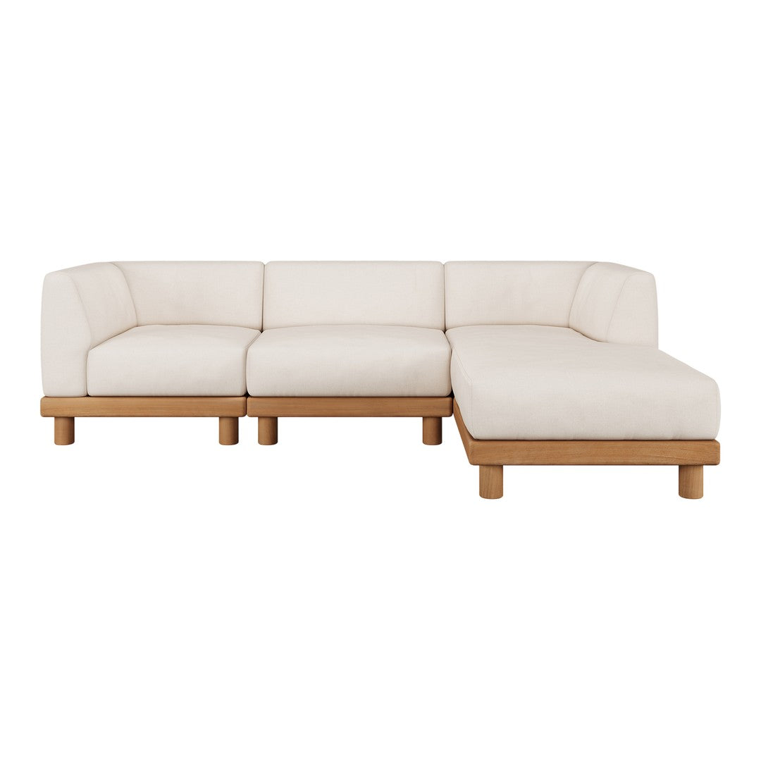 Cream-colored sectional sofa with a minimalist design and natural wood legs, featuring a smooth, textured fabric.
