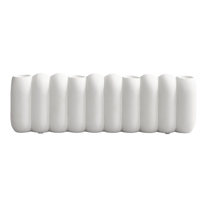 Sleek white vase with a textured, wavy pattern, showcasing a modern and minimalist design.