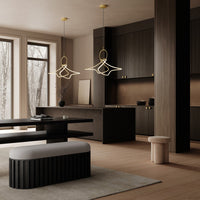Modern kitchen with dark wood cabinets, light beige walls, soft gray bench, and golden pendant lights with unique patterns.