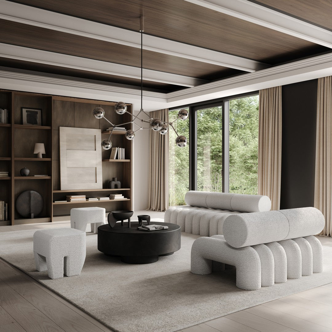 Modern living room featuring soft gray textures, black accents, warm wood tones, and neutral beige elements.