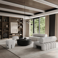 Modern living room featuring soft gray textures, black accents, warm wood tones, and neutral beige elements.