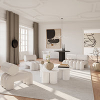 Stylish living room featuring beige curtains, soft white furniture, and earthy-toned decor on a light rug.