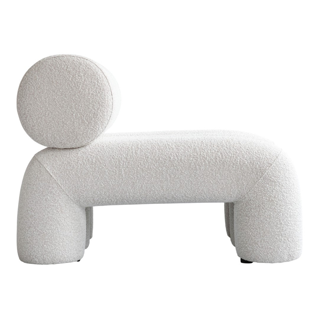 Textured light beige lounge chair with a rounded backrest and soft, plush fabric. Modern, minimalist design.