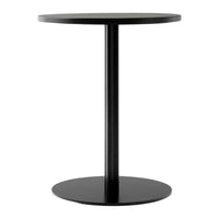 Black round side table with a sleek, minimalist design and smooth surface. Perfect for modern decor.