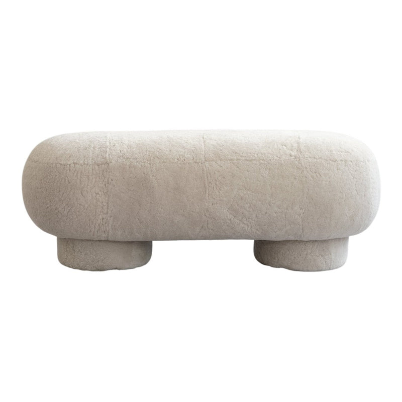 Soft beige upholstered ottoman with a textured, fluffy surface and rounded, minimalistic design.