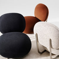 Three modern chairs in rich brown, deep black, and textured light gray, showcasing soft, round shapes and contrasting patterns.