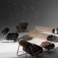 Chic brown and black patterned lounge furniture with sleek chrome accents on a soft gray backdrop.