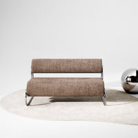 Brown textured sofa on a soft beige rug, paired with a shiny silver accent ball.