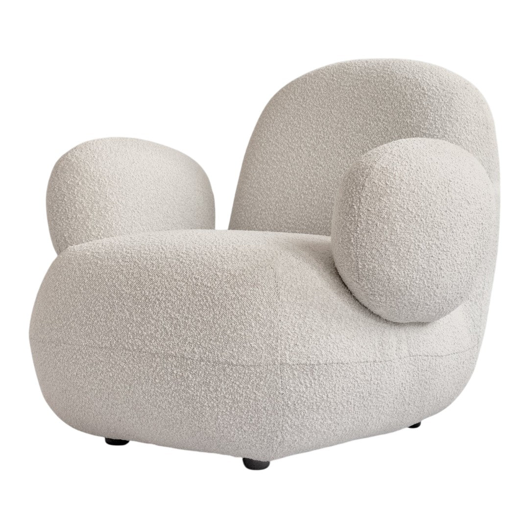 Cream-colored chair with soft, textured fabric and rounded shapes for a cozy, modern look.