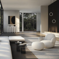 Modern living room with neutral tones, textured white furniture, and a graphic black and beige wall art piece.