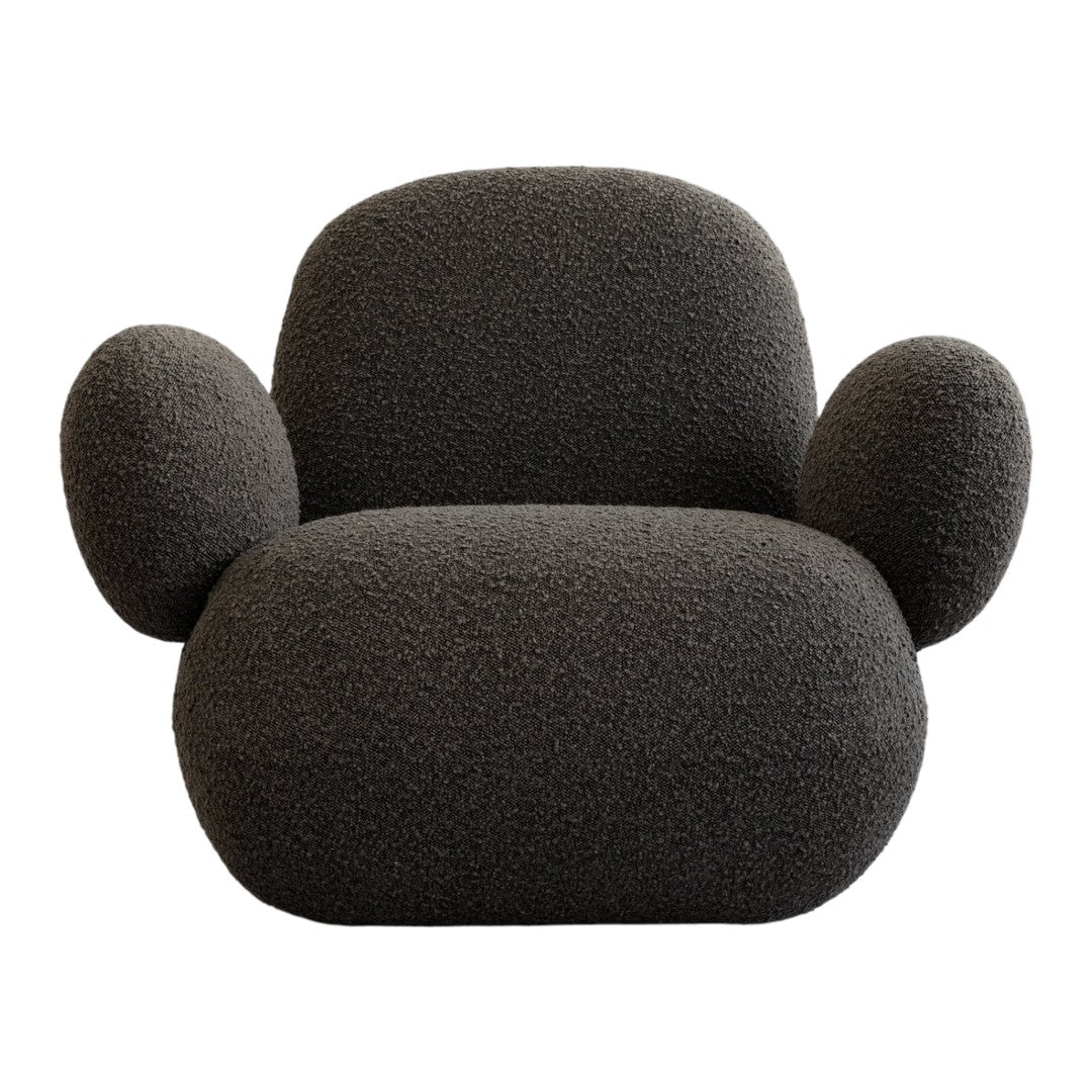 Cozy black textured armchair with rounded shapes and plush fabric, perfect for modern interiors.