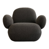 Cozy black textured armchair with rounded shapes and plush fabric, perfect for modern interiors.