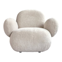 Cozy cream-colored chair with soft, textured fabric and rounded shapes for a modern, stylish look.