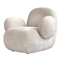 Cream-colored plush armchair with rounded shapes and soft texture, perfect for modern decor.