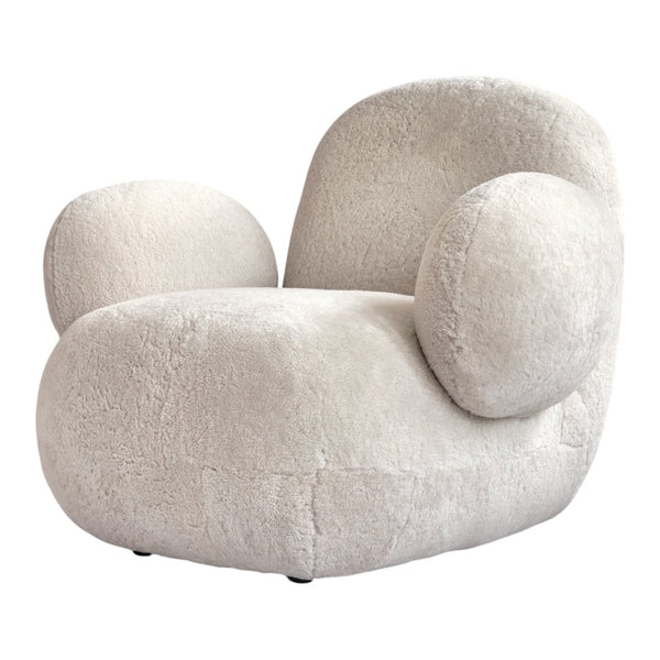 Cream-colored plush armchair with rounded shapes and soft texture, perfect for modern decor.