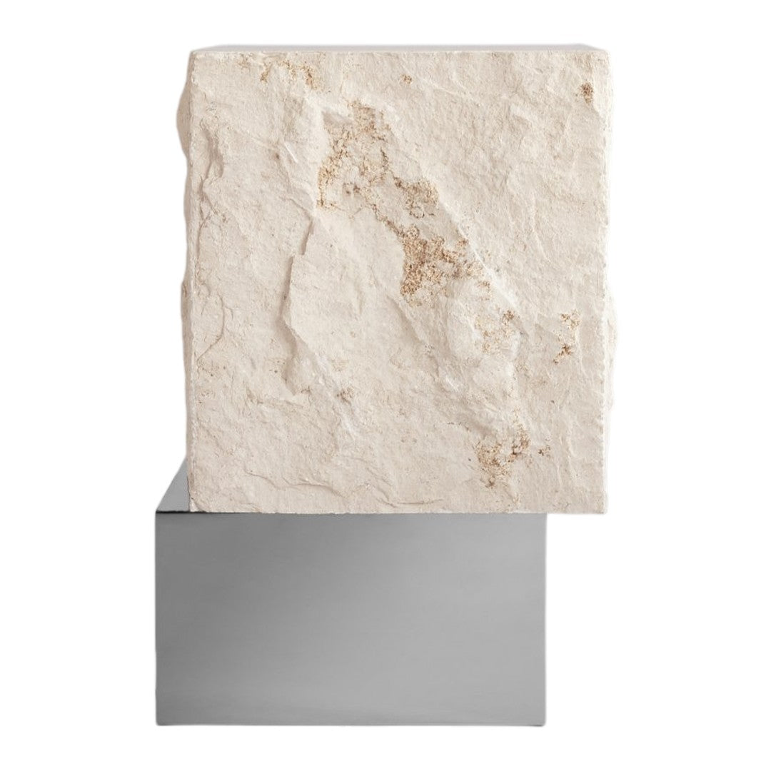 White textured stone atop a sleek, reflective silver base, showcasing natural patterns and subtle earth tones.
