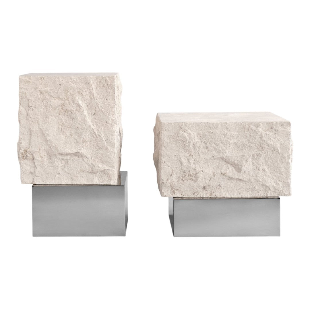 Square stone bookends with a textured white surface on sleek silver bases, creating a modern contrast.