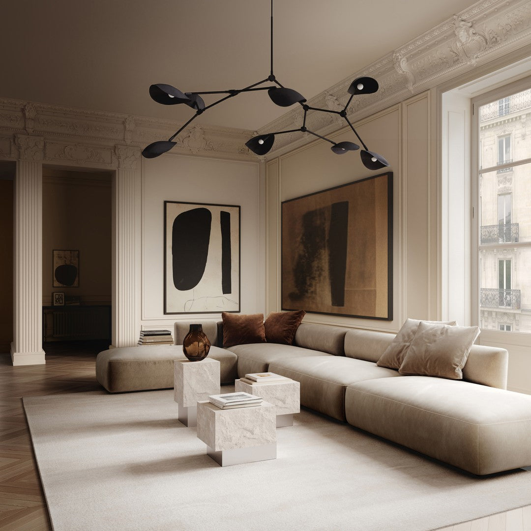 Modern living room with neutral beige sofa, dark black lamp, and abstract art in earthy tones. Clean, minimalist design.