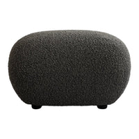 Textured gray ottoman with a rounded shape, featuring a soft, plush fabric pattern for a modern look.