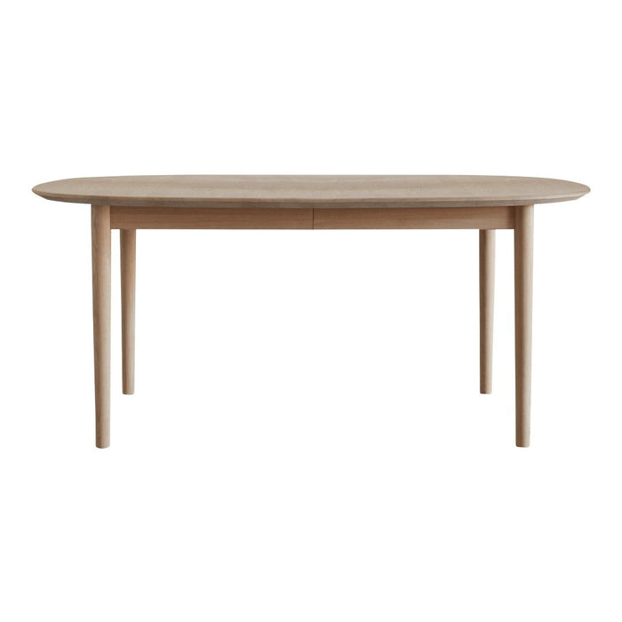 Light oak wood dining table with a smooth, oval surface and tapered legs, showcasing a natural finish and subtle grain patterns.