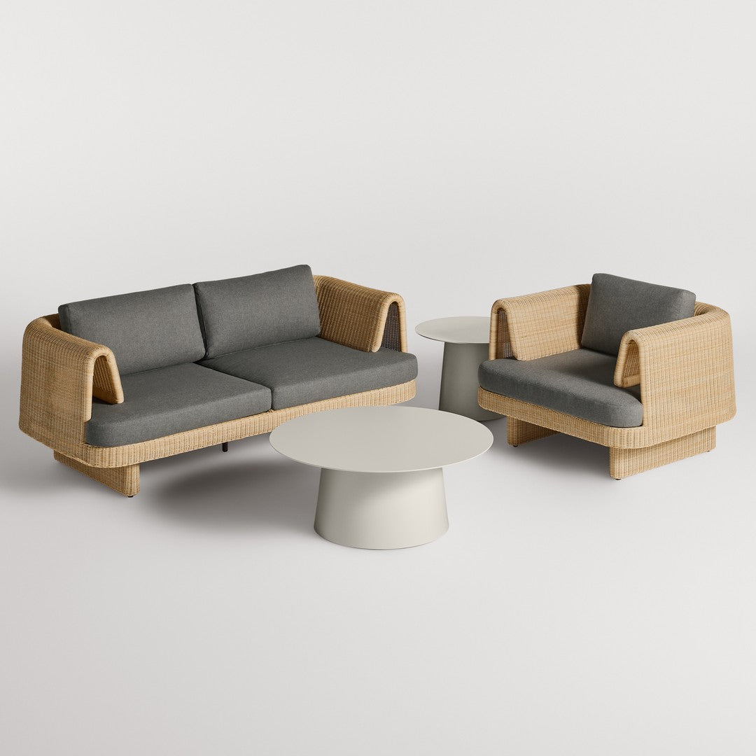 Stylish outdoor furniture set featuring grey cushions and natural rattan weave against a minimalist white table.