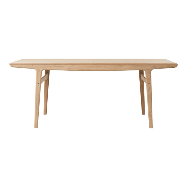 Light natural wood dining table with a smooth finish and minimalist design, featuring clean lines and no patterns.