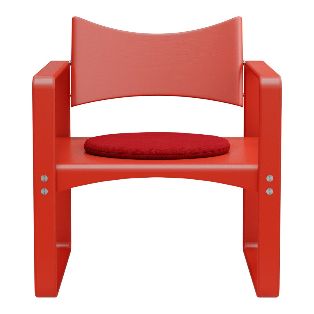 Red wooden chair with a curved back and a round red cushion, featuring smooth surfaces and a modern design.