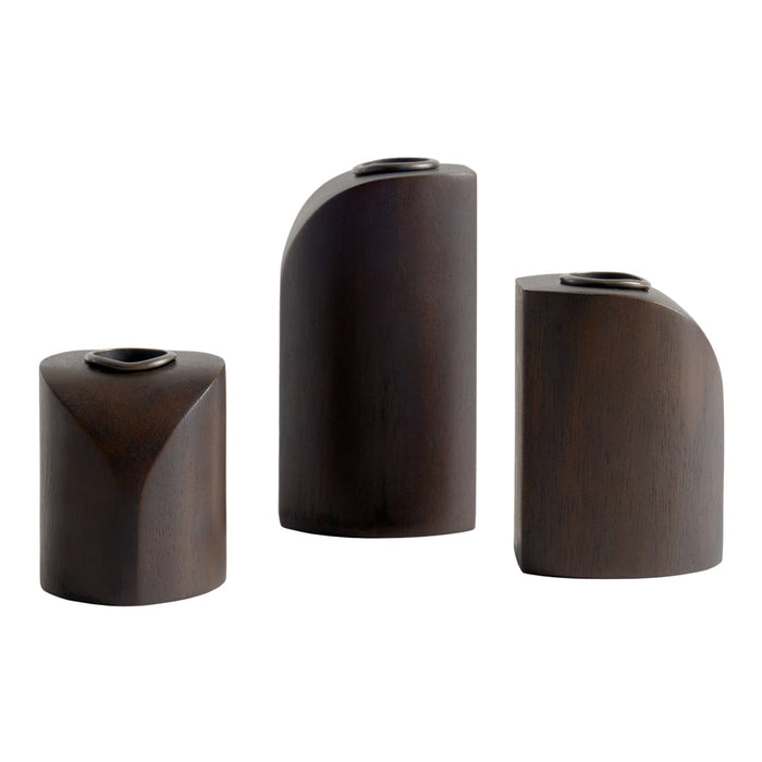 Set of three modern dark wood vases with curved geometric shapes and smooth finishes. Perfect for stylish decor.