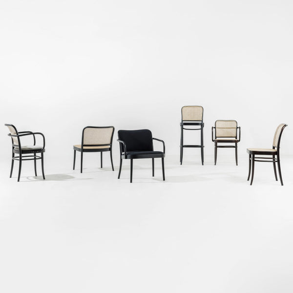 "Set of chairs featuring black and beige upholstery with a sleek, modern design and minimalistic patterns."