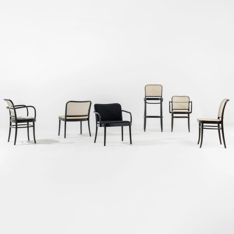 "Set of chairs featuring black and beige upholstery with a sleek, modern design and minimalistic patterns."